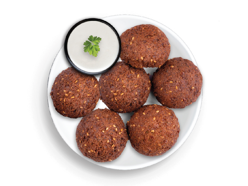Falafel made with chickpeas and herbs, shown with a selection of dipping sauces