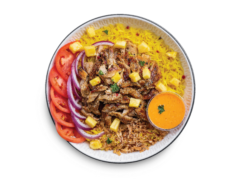 Jerk chicken shawarma served over basmati rice with pineapple, onions, parsley, tomatoes, spicy garlic and garlic sauce