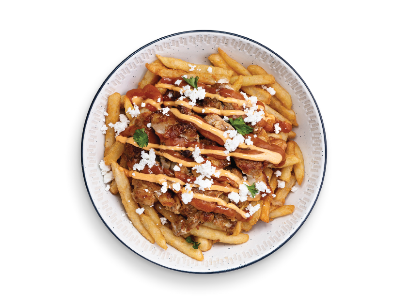 Fries topped with shawarma toppings, messy sauce, garlic sauce and parsley