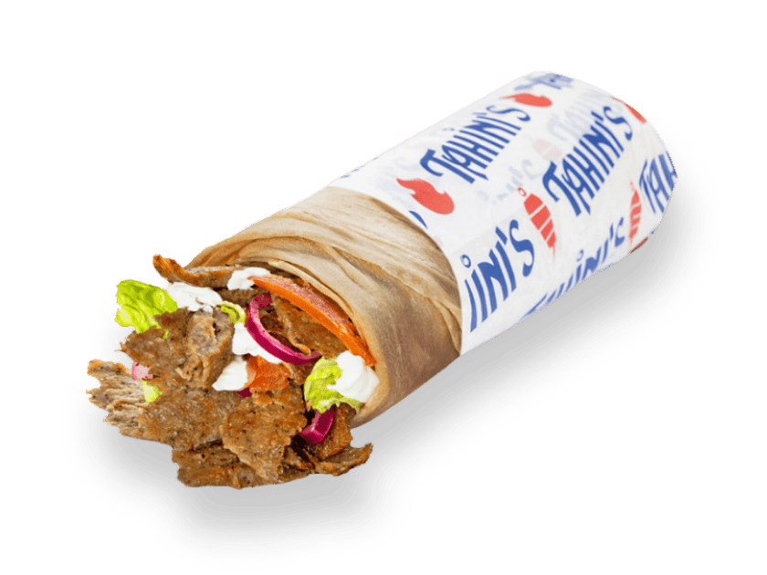 Sliced beef and lamb gyro wrap rolled in saj bread with tomatoes and lettuce